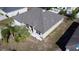 An elevated view showing well maintained landscaping with white rock accents and a pristine gray roof at 1956 Myakka Ct, Poinciana, FL 34759
