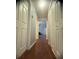 Bright hallway with wood flooring, leading to other rooms at 1956 Myakka Ct, Poinciana, FL 34759