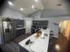 Spacious kitchen featuring stainless steel appliances, ample cabinet space, and a stylish breakfast bar at 1956 Myakka Ct, Poinciana, FL 34759