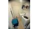 Bright laundry room with white washer and dryer plus ample shelf storage for cleaning supplies and folded towels at 1956 Myakka Ct, Poinciana, FL 34759