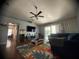 Inviting living area with comfortable seating, entertainment center, and access to outdoor views through sliding doors at 1956 Myakka Ct, Poinciana, FL 34759
