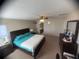 Spacious primary bedroom includes king bed, and en suite bathroom access at 1956 Myakka Ct, Poinciana, FL 34759