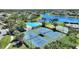 Aerial view showcasing community pool, tennis courts, lake and surrounding homes at 2629 Maggiore Cir, Kissimmee, FL 34746