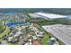 Aerial view of community homes, landscaping, pond, and large building in background at 2629 Maggiore Cir, Kissimmee, FL 34746