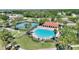 Aerial view of community pool, tennis courts, and lush landscaping at 2629 Maggiore Cir, Kissimmee, FL 34746