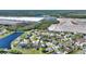 Aerial view of community homes, landscaping and pond, with building construction in background at 2629 Maggiore Cir, Kissimmee, FL 34746