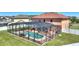 Aerial view of private backyard with an enclosed pool and patio, lawn, and privacy fence at 2629 Maggiore Cir, Kissimmee, FL 34746