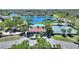 Aerial view showcasing community amenities including a pool, clubhouse, and tennis courts at 2629 Maggiore Cir, Kissimmee, FL 34746