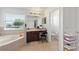 Bright bathroom featuring a single vanity, toilet, and a soaking tub at 2629 Maggiore Cir, Kissimmee, FL 34746