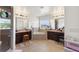 Bright bathroom featuring double vanities, soaking tub, and separate shower at 2629 Maggiore Cir, Kissimmee, FL 34746