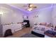 Cozy bedroom features a ceiling fan, carpeted floors, and a comfortable bed at 2629 Maggiore Cir, Kissimmee, FL 34746
