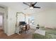 Bright bedroom featuring a ceiling fan, desk, and comfortable furnishings, bathed in natural light from the window at 2629 Maggiore Cir, Kissimmee, FL 34746