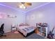 This cozy bedroom is illuminated by purple LED lights at 2629 Maggiore Cir, Kissimmee, FL 34746