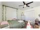 Bright bedroom with a ceiling fan, plush bedding, and ample closet space for storage at 2629 Maggiore Cir, Kissimmee, FL 34746