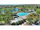 Aerial view of a large community pool with a splash pad and tennis courts, ideal for outdoor recreation at 2629 Maggiore Cir, Kissimmee, FL 34746