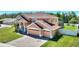 Two-story home with brick driveway, manicured lawn, and two-car garage with mature landscaping at 2629 Maggiore Cir, Kissimmee, FL 34746