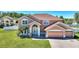 Charming two-story home featuring lush landscaping and a three-car garage at 2629 Maggiore Cir, Kissimmee, FL 34746