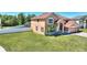 Two-story home with manicured lawn and landscaping, featuring a private backyard and an attached two car garage at 2629 Maggiore Cir, Kissimmee, FL 34746