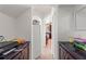 Hallway featuring built-in cabinetry, tile flooring, and an arched entryway at 2629 Maggiore Cir, Kissimmee, FL 34746