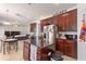 Spacious kitchen with a granite island, stainless steel appliances, and dark wood cabinets at 2629 Maggiore Cir, Kissimmee, FL 34746