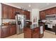 The kitchen offers dark wood cabinets, stainless steel appliances, and granite countertops at 2629 Maggiore Cir, Kissimmee, FL 34746