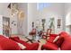 Spacious living room featuring a high ceiling, tile floors, and plenty of natural light from the large windows at 2629 Maggiore Cir, Kissimmee, FL 34746