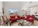 Bright living room featuring tile floors, vaulted ceiling, and large windows offering plenty of natural light at 2629 Maggiore Cir, Kissimmee, FL 34746