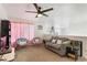 Comfortable living room featuring a ceiling fan, large windows, and neutral carpeting at 2629 Maggiore Cir, Kissimmee, FL 34746