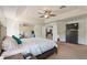 Large main bedroom with neutral carpet, ceiling fan, and ensuite access at 2629 Maggiore Cir, Kissimmee, FL 34746