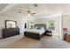 Bright main bedroom with neutral carpet, ceiling fan, and bright, airy windows at 2629 Maggiore Cir, Kissimmee, FL 34746