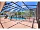 Covered and enclosed backyard swimming pool with safety fence, offering a private and secure outdoor oasis at 2629 Maggiore Cir, Kissimmee, FL 34746
