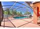 Enclosed swimming pool with black safety fence, lush greenery, and plenty of space for relaxation and leisure at 2629 Maggiore Cir, Kissimmee, FL 34746