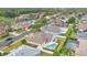 Aerial view of a beautiful home with a backyard pool, patio, and lush landscaping at 2877 Ashton Ter, Oviedo, FL 32765