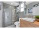 Contemporary bathroom with a glass-enclosed shower, modern fixtures, and stylish gray tile throughout at 2877 Ashton Ter, Oviedo, FL 32765