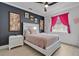 Charming bedroom with a comfortable bed, stylish decor, and bright pink curtains framing the window at 2877 Ashton Ter, Oviedo, FL 32765