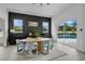 Bright dining room with a modern table, stylish chairs, and views of the backyard pool through sliding glass doors at 2877 Ashton Ter, Oviedo, FL 32765