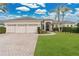 Charming single-story home boasting a three-car garage, manicured lawn, and tropical landscaping at 2877 Ashton Ter, Oviedo, FL 32765