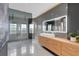 Sleek main bathroom with a modern vanity, large mirror, and a spacious glass-enclosed shower with dual shower heads at 2877 Ashton Ter, Oviedo, FL 32765