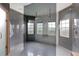 Elegant main bathroom showcasing a large glass-enclosed shower with dual shower heads and modern gray tiling at 2877 Ashton Ter, Oviedo, FL 32765
