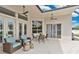 Inviting outdoor patio with comfortable seating, ceiling fans, and views of the landscaped backyard at 2877 Ashton Ter, Oviedo, FL 32765