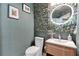 Chic powder room featuring a decorative wall, vessel sink, and round LED mirror at 2877 Ashton Ter, Oviedo, FL 32765
