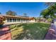 Expansive backyard with a well-maintained lawn, patio, privacy fence, and mature trees, creating a serene outdoor space at 300 Radebaugh Dr, Longwood, FL 32779