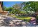 Spacious backyard features a well-manicured lawn, patio, shed, mature trees, and a privacy fence at 300 Radebaugh Dr, Longwood, FL 32779