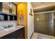 Bathroom featuring a dark vanity, tiled shower, and decorative accents at 300 Radebaugh Dr, Longwood, FL 32779