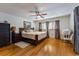 Cozy bedroom featuring hardwood floors, a ceiling fan, and a comfortable bed at 300 Radebaugh Dr, Longwood, FL 32779