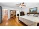 Bright bedroom with hardwood floors, a ceiling fan, and an ensuite bathroom entrance at 300 Radebaugh Dr, Longwood, FL 32779