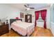 Bright bedroom featuring a comfortable bed, wood floors, and ample natural light at 300 Radebaugh Dr, Longwood, FL 32779