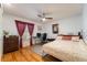 Inviting bedroom with wood floors, a ceiling fan, and a dedicated workspace area at 300 Radebaugh Dr, Longwood, FL 32779