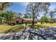 Single story home with manicured lawn, mature shade tree, and stone facade entrance at 300 Radebaugh Dr, Longwood, FL 32779
