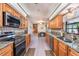 Bright kitchen with granite countertops, stainless steel appliances, and light hardwood floors at 300 Radebaugh Dr, Longwood, FL 32779